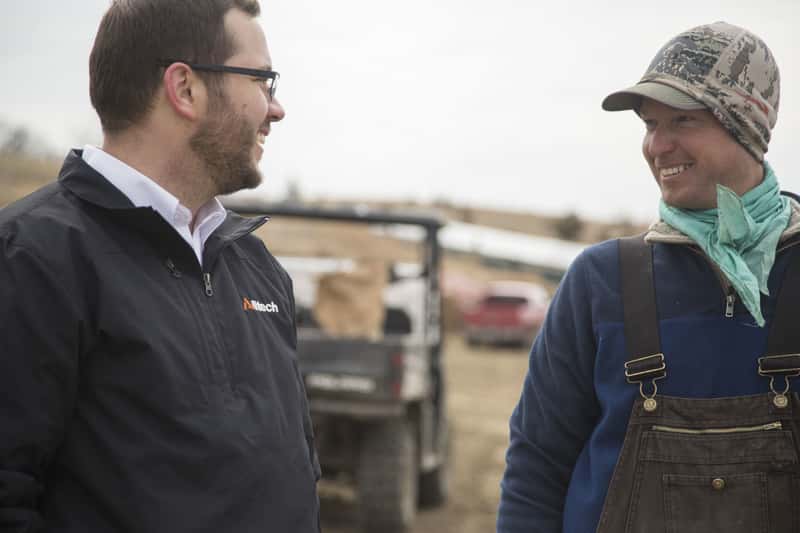 alltech sales rep with customer on-farm