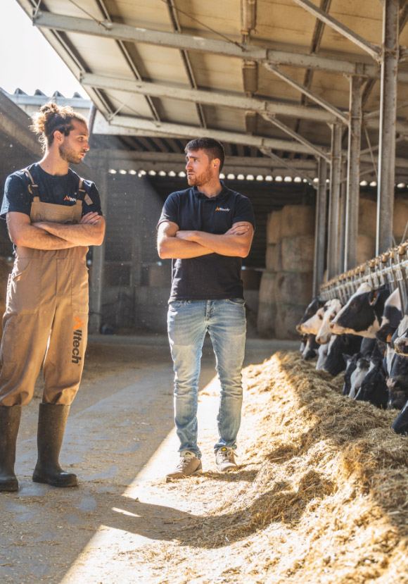 Alltech rep and a farmer in a dairy barn